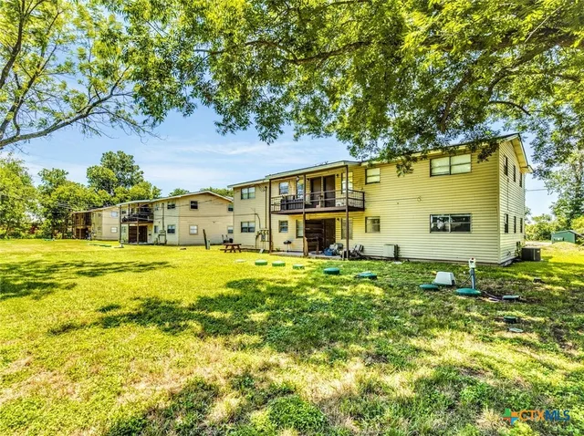 a view of a park with large trees