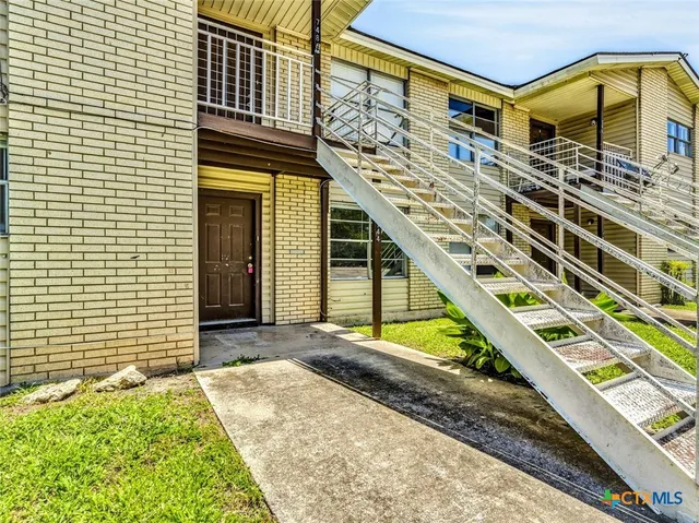 a front view of a house with large windows