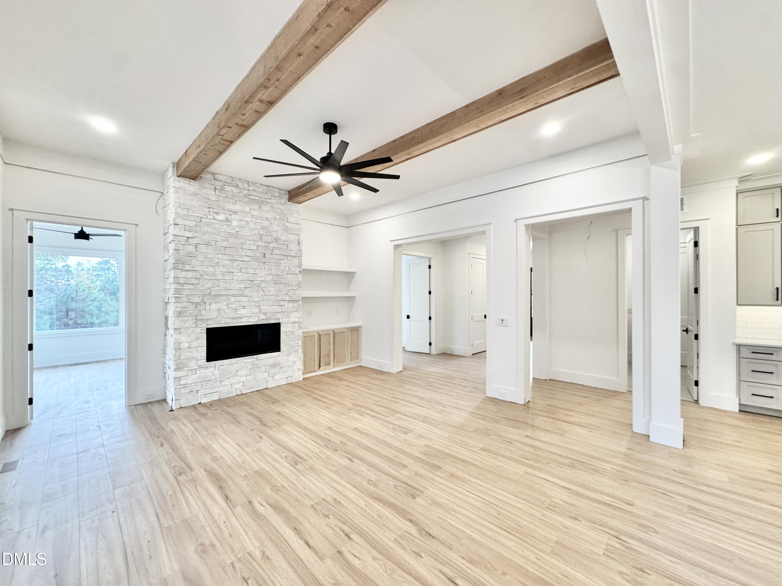 8012 Penny Road Raleigh, NC 27606 - Photo 11 of 83 a view of an empty room with wooden floor and a kitchen