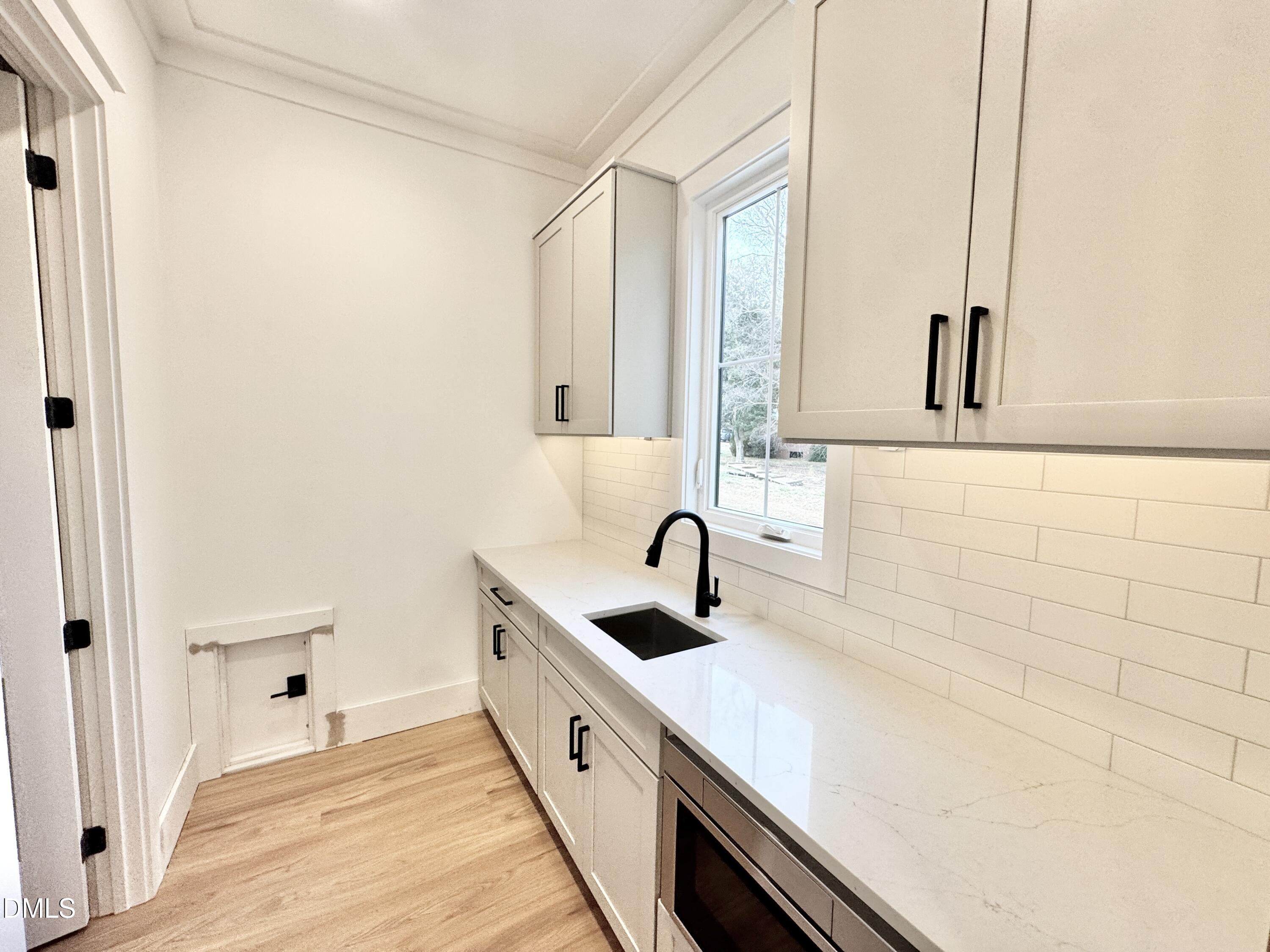 8012 Penny Road Raleigh, NC 27606 - Photo 21 of 83 a bathroom with a sink and a large mirror