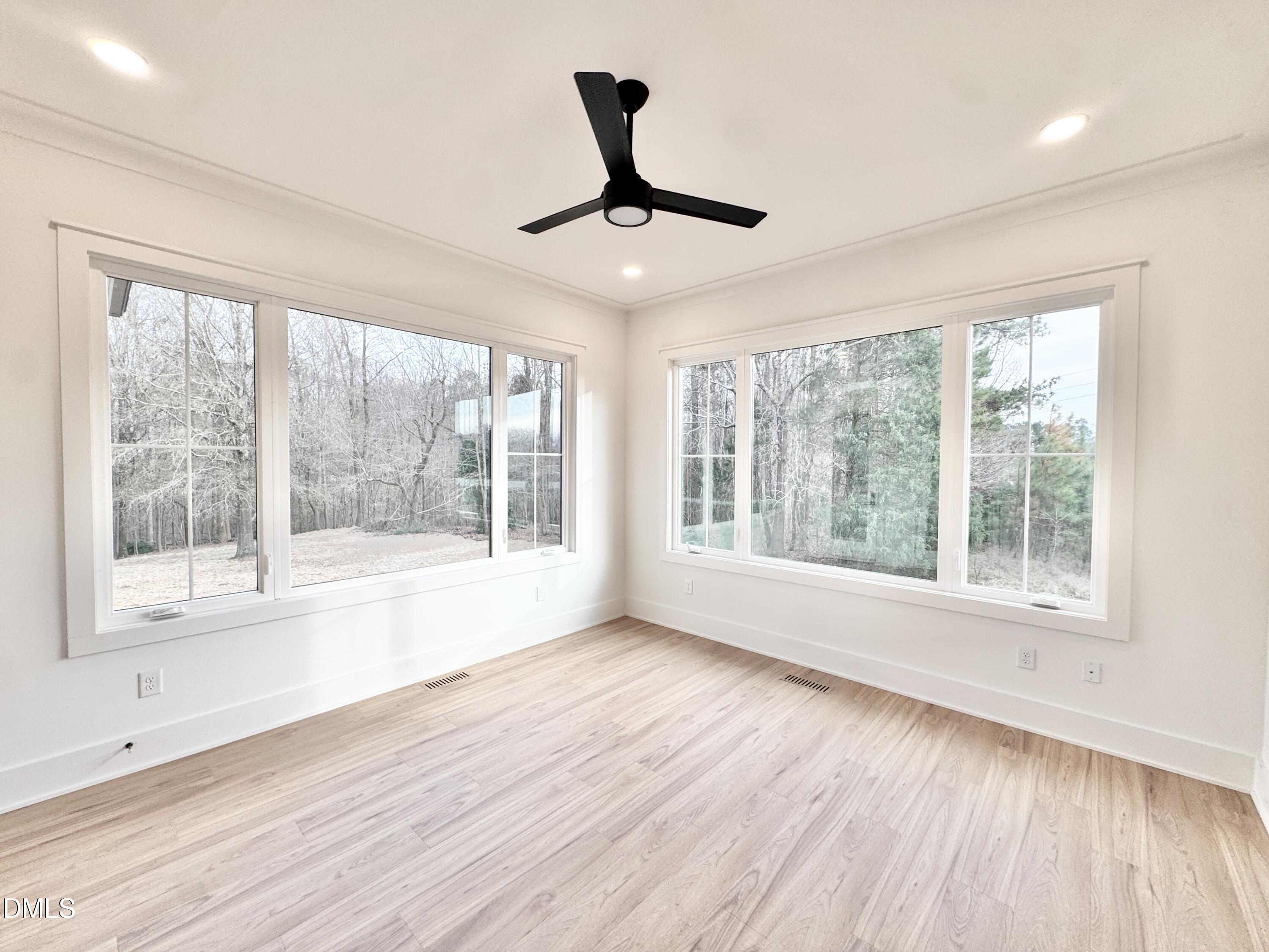 8012 Penny Road Raleigh, NC 27606 - Photo 24 of 83 a view of an empty room with wooden floor and a window