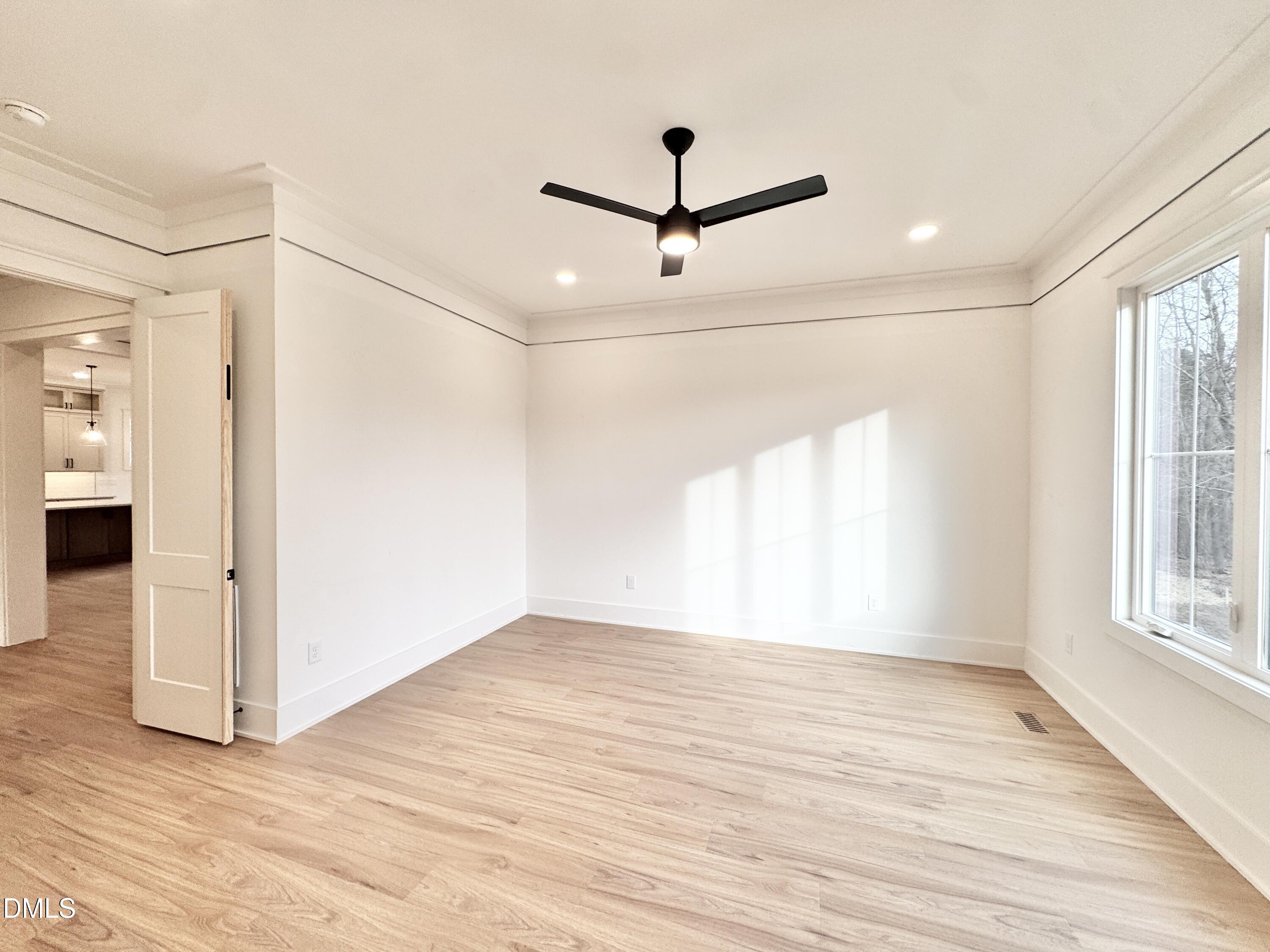 8012 Penny Road Raleigh, NC 27606 - Photo 28 of 83 a view of empty room with wooden floor and fan