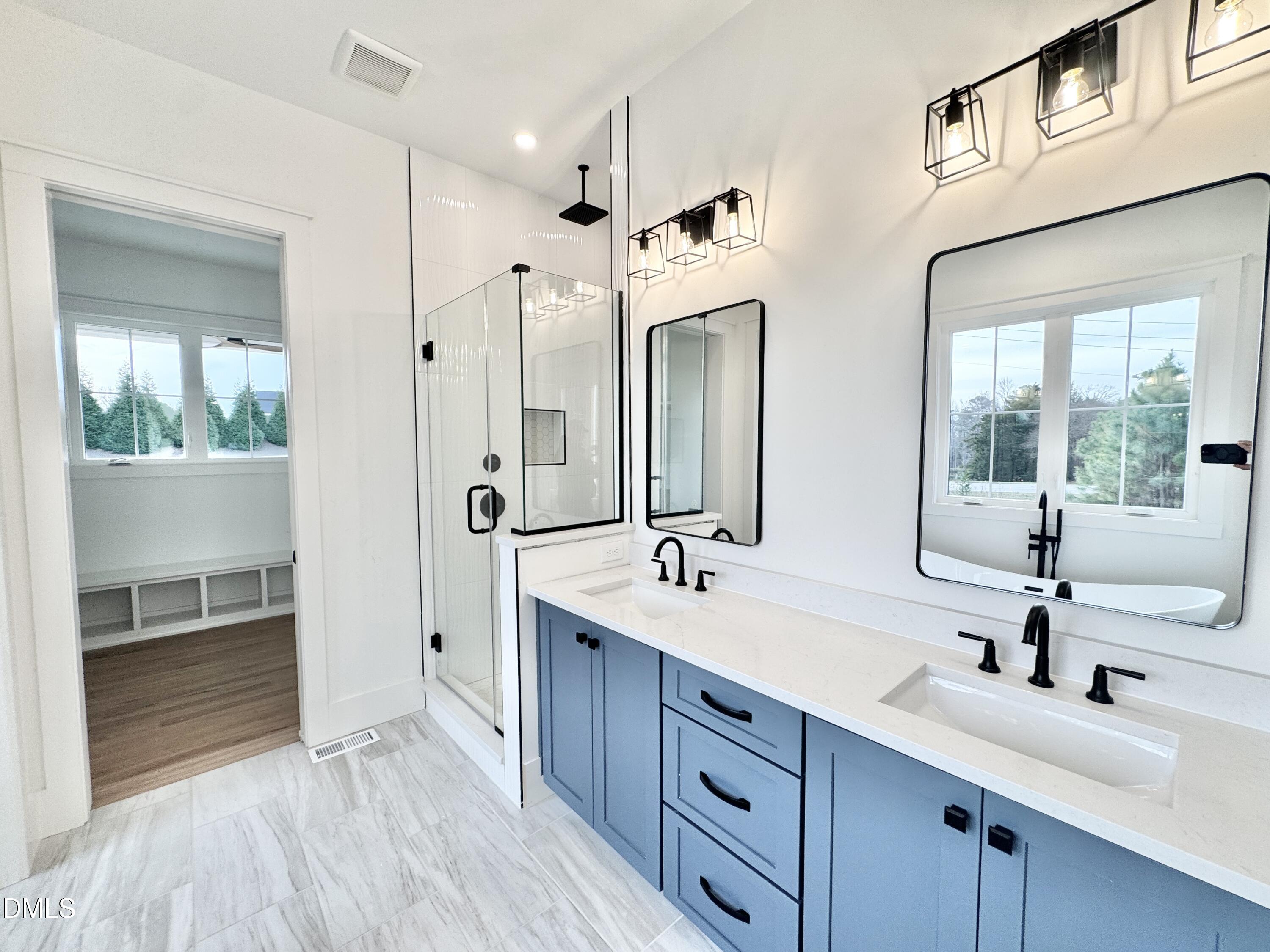 8012 Penny Road Raleigh, NC 27606 - Photo 31 of 83 a bathroom with a double vanity sink mirror and shower