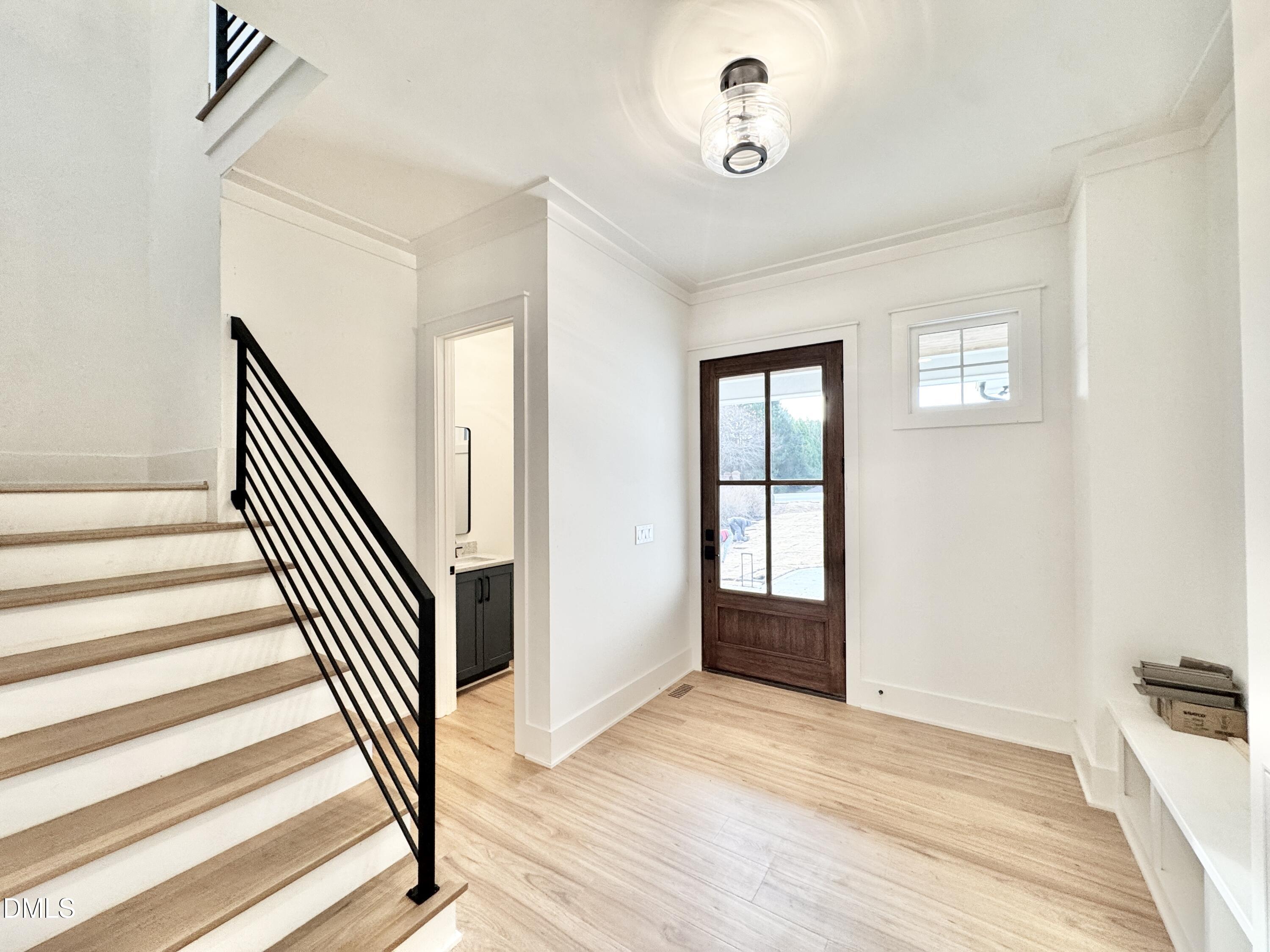 8012 Penny Road Raleigh, NC 27606 - Photo 4 of 83 a view of a hallway with wooden floor and staircase
