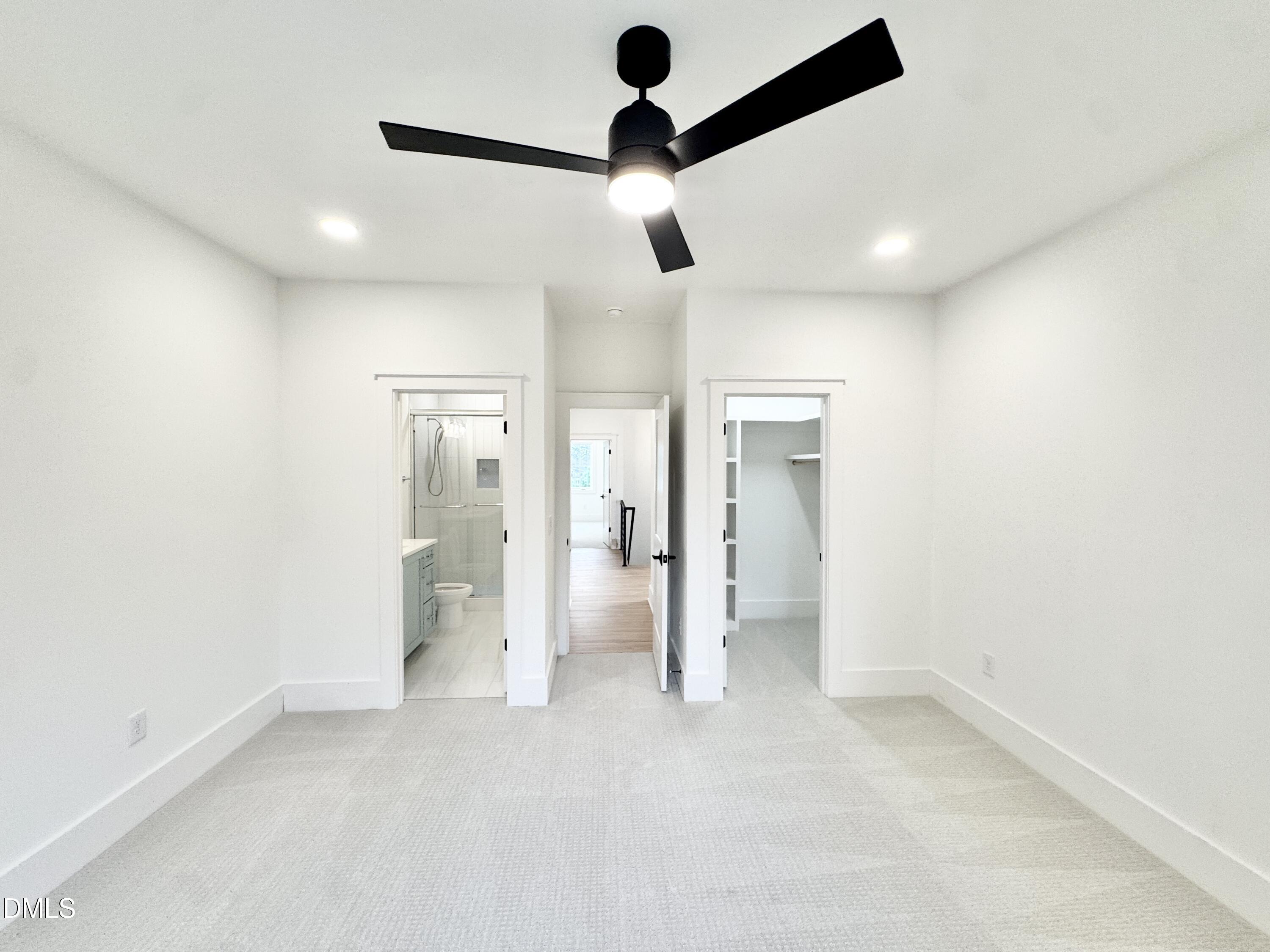 8012 Penny Road Raleigh, NC 27606 - Photo 62 of 83 an empty room with closet and a chandelier fan