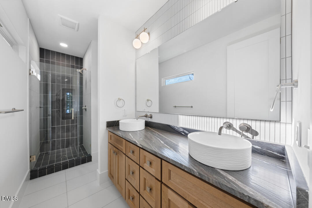 2530 West Wilson Street Durham, NC 27705 - Photo 27 of 49 a bathroom with a granite countertop sink and a mirror