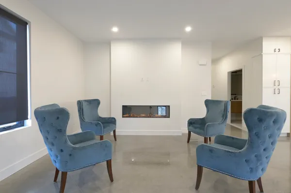 a living room with furniture and a chair