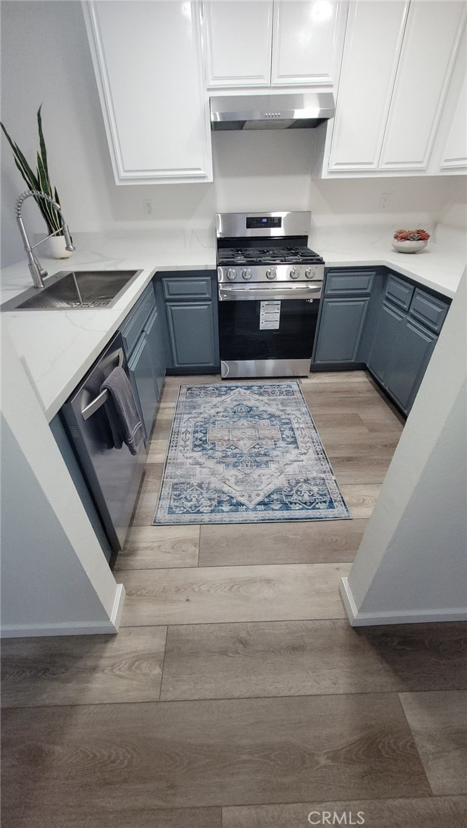 700 West 2nd Street, Unit 3 Azusa, CA 91702 - Photo 4 of 17 a kitchen with a stove and white cabinets