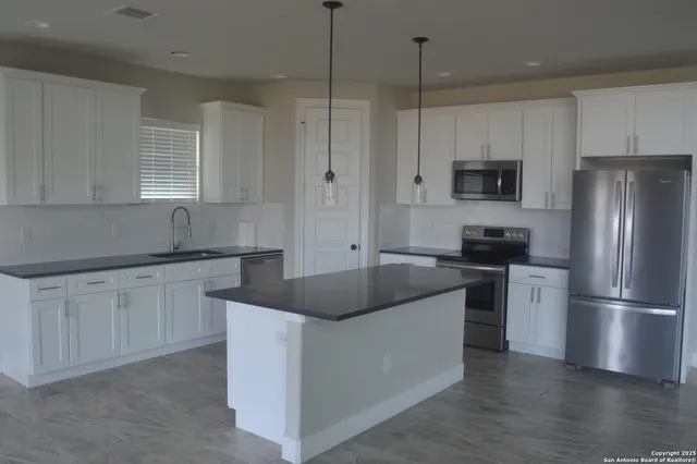a kitchen with a refrigerator and a sink
