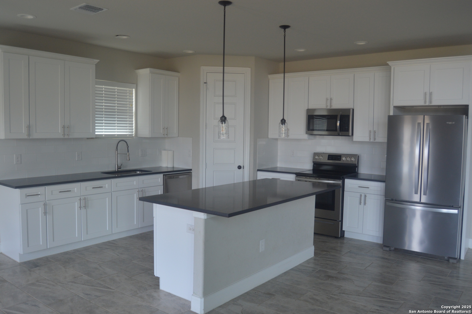 153 West Medium Meadow Drive Lytle, TX 78052 - Photo 16 of 26 a kitchen with a refrigerator and a sink