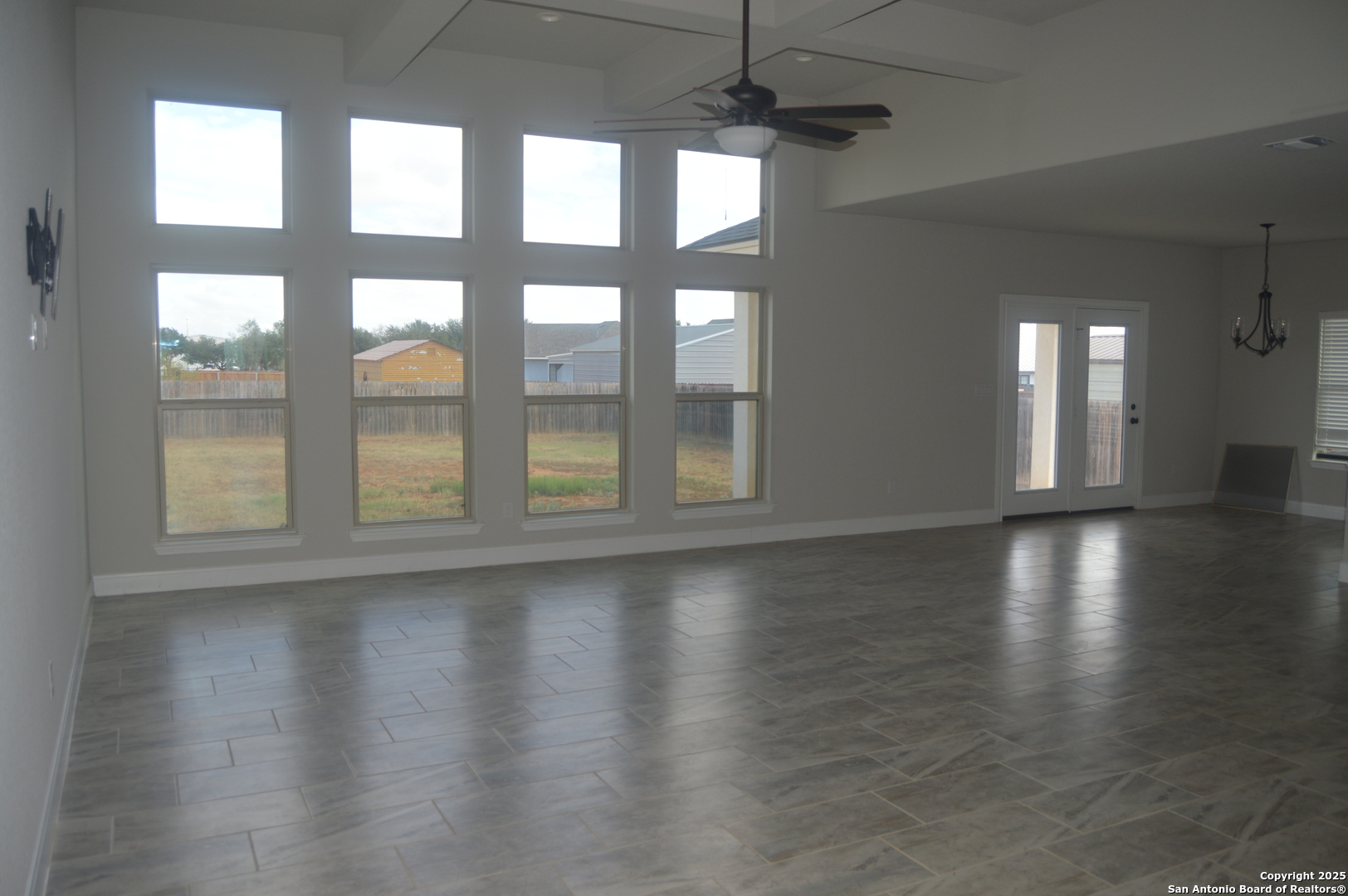 153 West Medium Meadow Drive Lytle, TX 78052 - Photo 6 of 26 a view of an empty room with wooden floor and a window