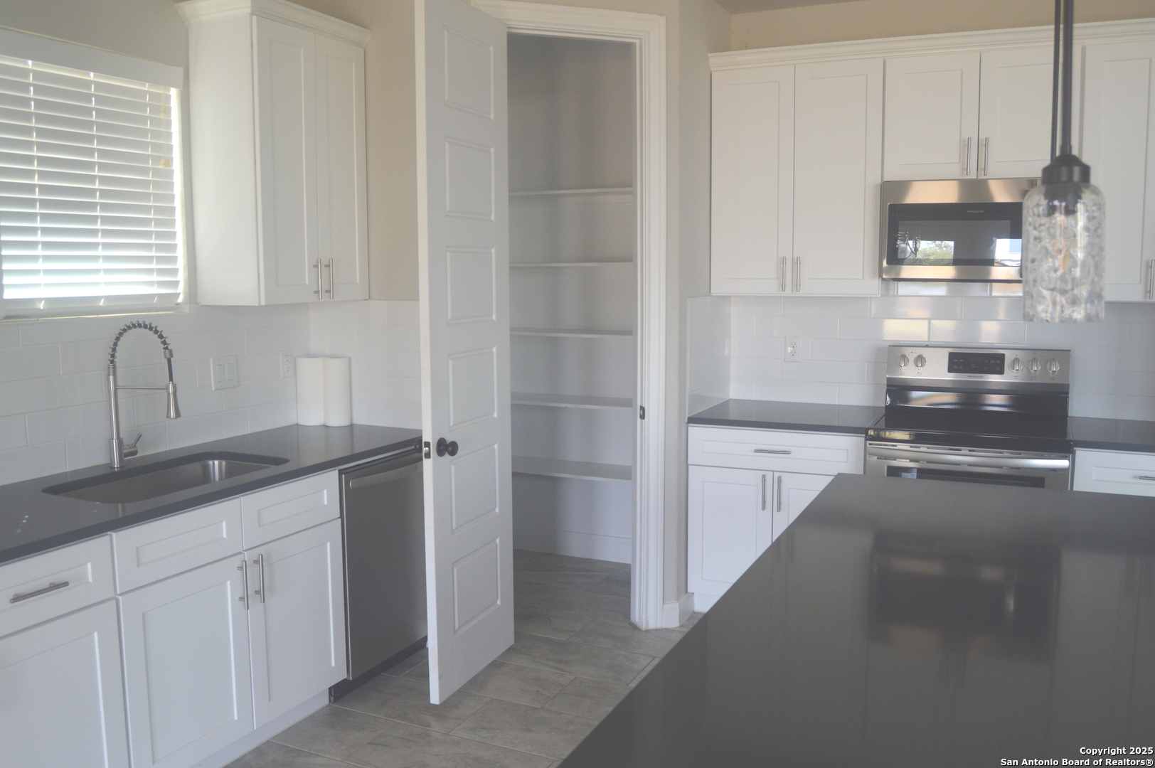 153 West Medium Meadow Drive Lytle, TX 78052 - Photo 9 of 26 a kitchen with a sink and cabinets