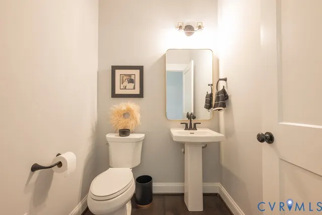 a bathroom with a toilet a sink and mirror