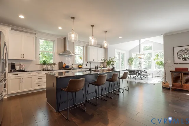 a kitchen with lots of counter space a sink appliances and a large window