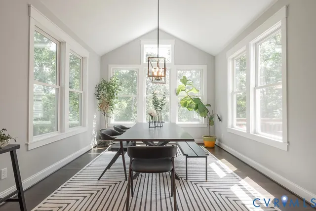 a dining room with furniture a window and a chandelier