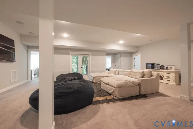 a living room with furniture and a mirror