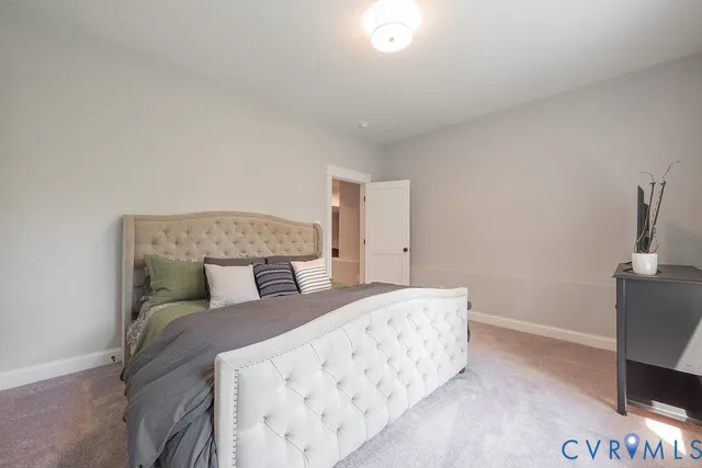 a bedroom with two bed and a desk