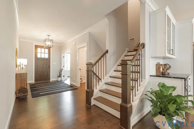 a view of entryway and hall with wooden floor