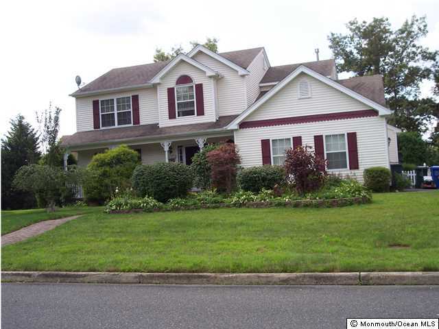 101 Compass Road Manahawkin, NJ 08050 - Photo 1 of 3 a front view of a house with a yard and garage