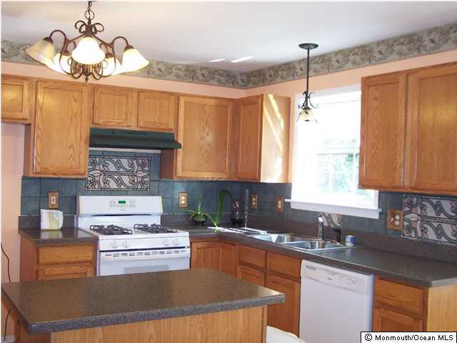 101 Compass Road Manahawkin, NJ 08050 - Photo 3 of 3 a kitchen with kitchen island granite countertop a sink cabinets and window