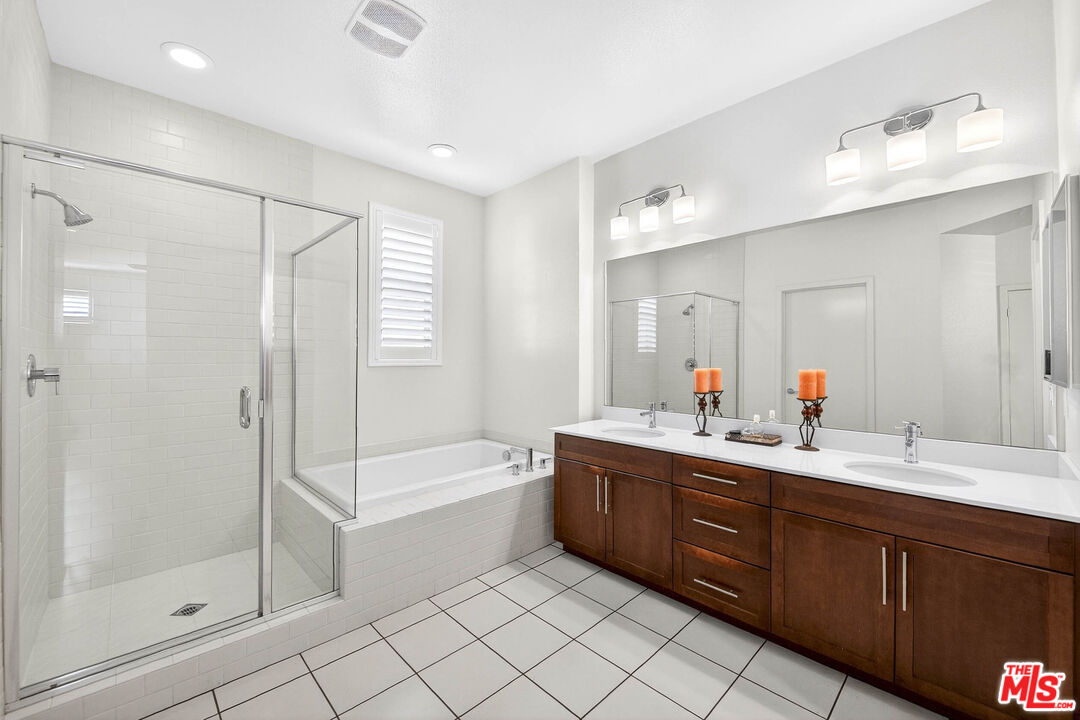707 Colorado Circle Carson, CA 90745 - Photo 13 of 40 a bathroom with a double vanity sink mirror and shower