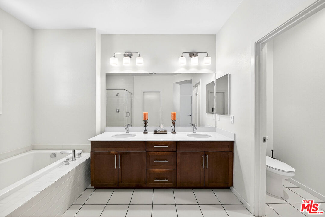707 Colorado Circle Carson, CA 90745 - Photo 14 of 40 a spacious bathroom with a granite countertop double vanity sink mirror and bathtub