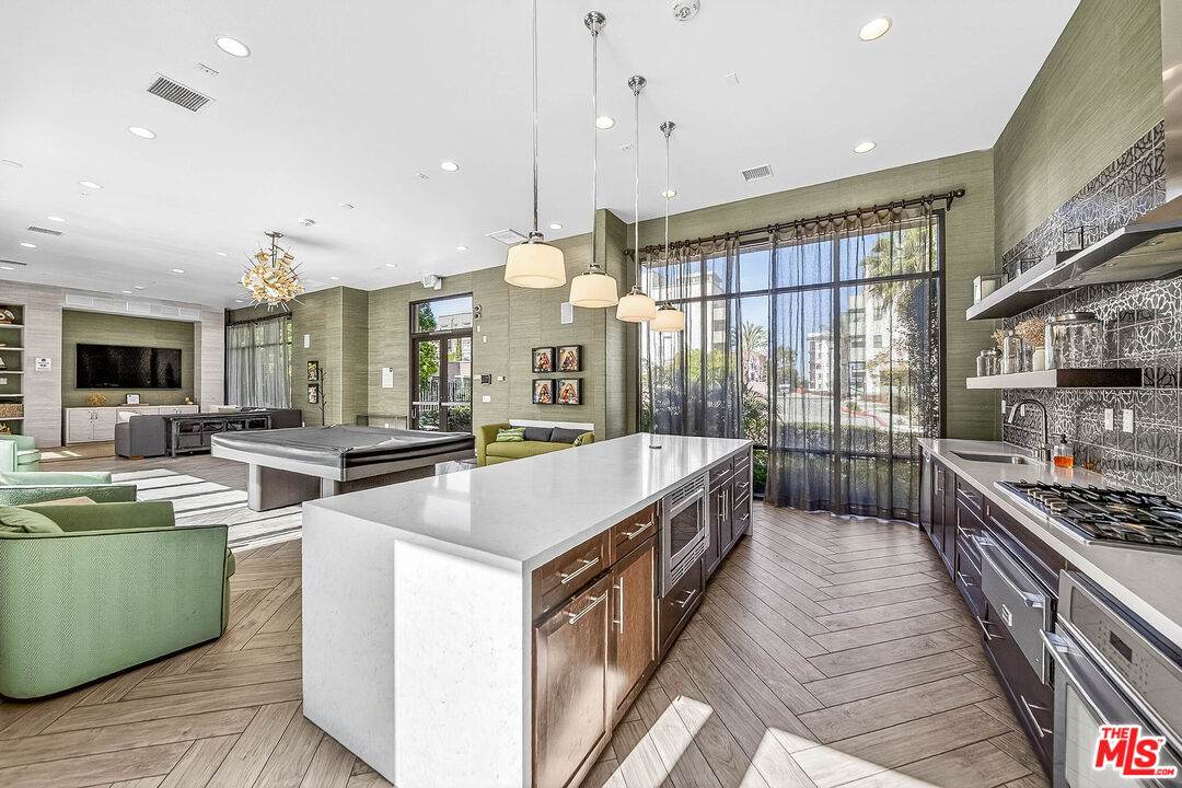 707 Colorado Circle Carson, CA 90745 - Photo 37 of 40 a kitchen with stainless steel appliances granite countertop a sink and a stove