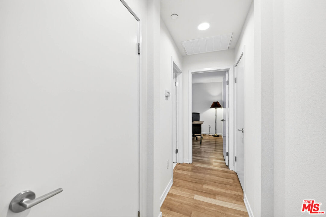 707 Colorado Circle Carson, CA 90745 - Photo 8 of 40 a view of a hallway with wooden floor and a bathroom