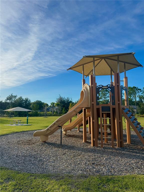 2787 Raindrop Run Street Clermont, FL 34714 - Photo 16 of 18 a view of a swimming pool with a patio and a yard