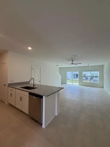 a kitchen with stainless steel appliances granite countertop a sink and a stove