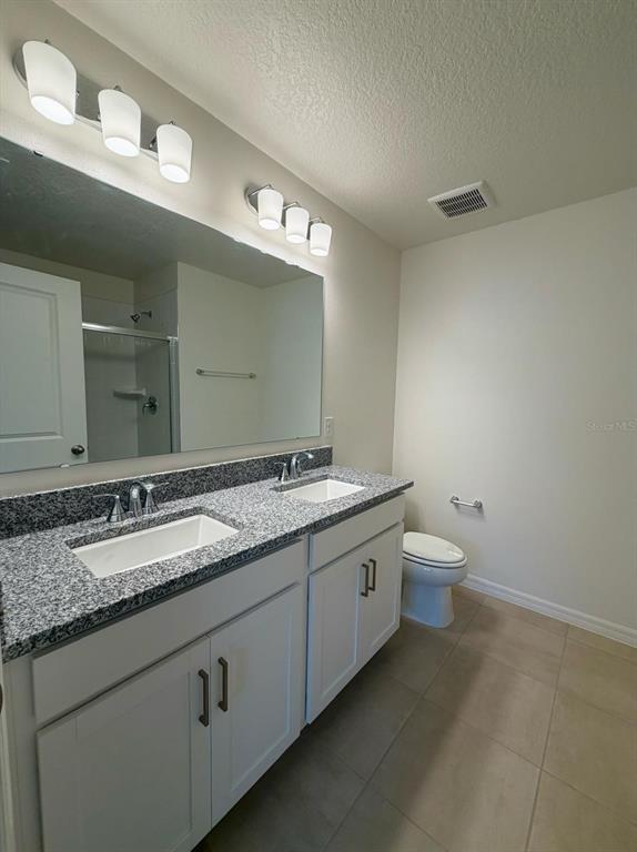 2787 Raindrop Run Street Clermont, FL 34714 - Photo 10 of 18 a bathroom with a granite countertop sink and a mirror