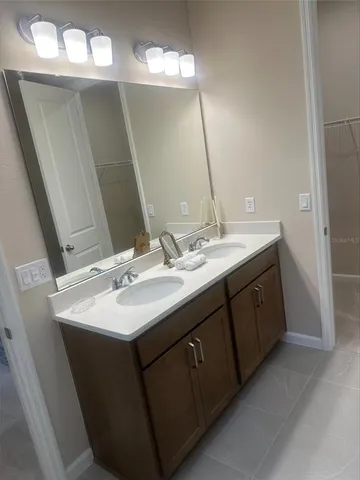 a bathroom with a double vanity sink and a mirror