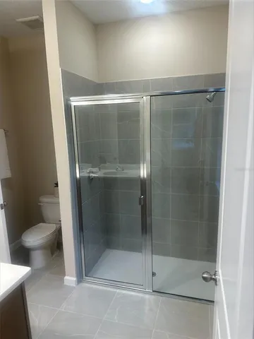 a bathroom with a glass door shower
