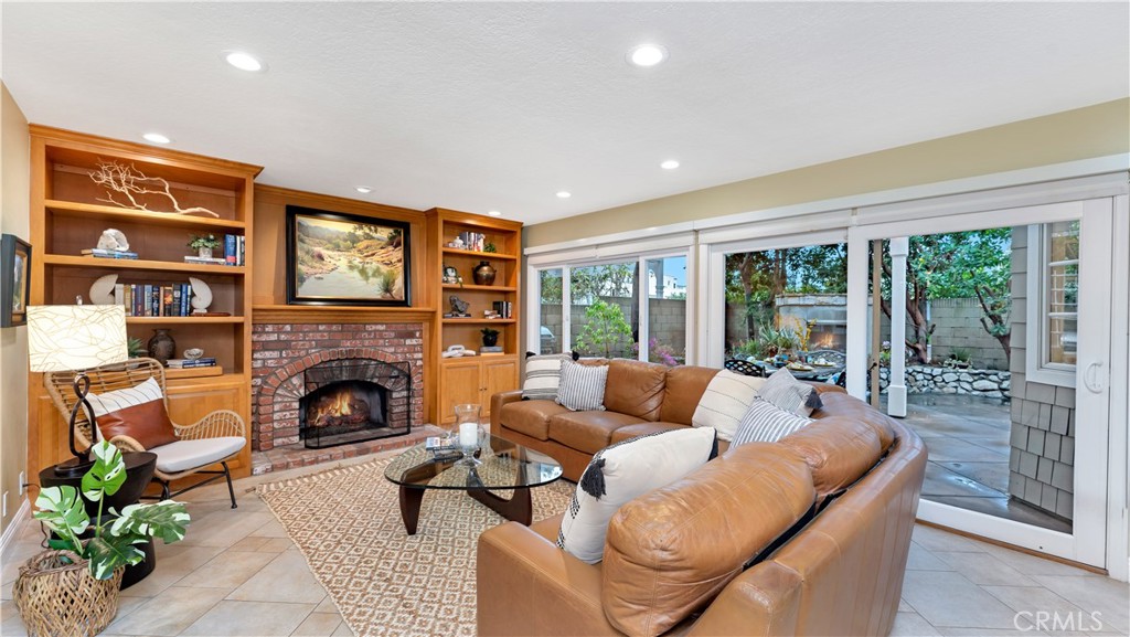 2 Rainstar Irvine, CA 92614 - Photo 18 of 49 a living room with furniture a fireplace and a floor to ceiling window