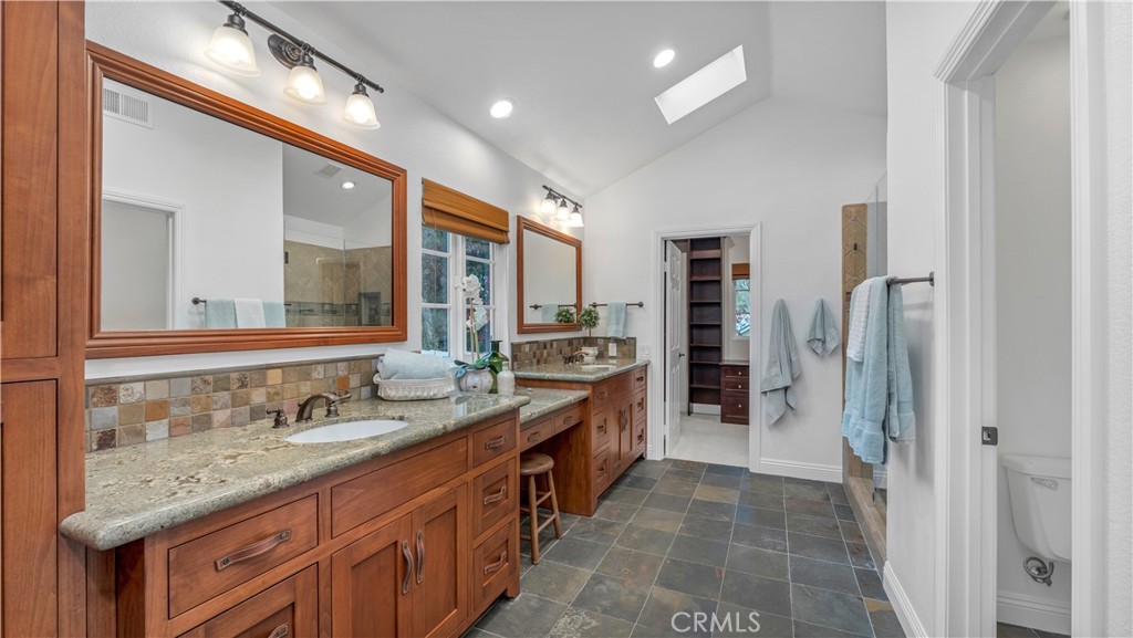2 Rainstar Irvine, CA 92614 - Photo 39 of 49 a spacious bathroom with a granite countertop sink and a mirror