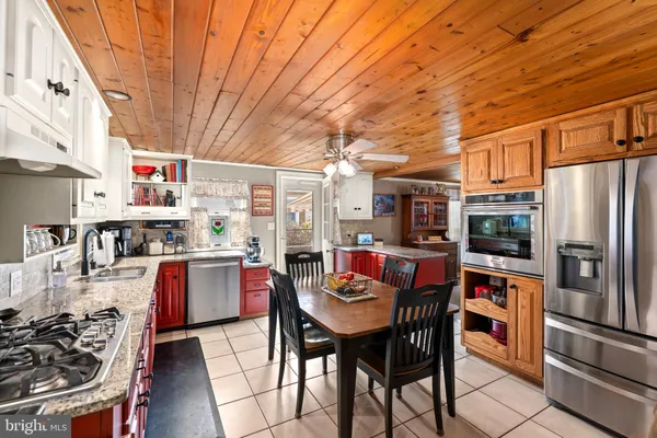 a kitchen with stainless steel appliances a stove a sink dishwasher and cabinets