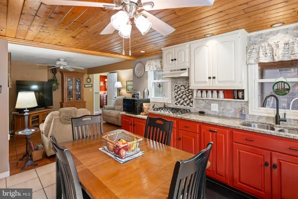 a large kitchen with a table and chairs in it