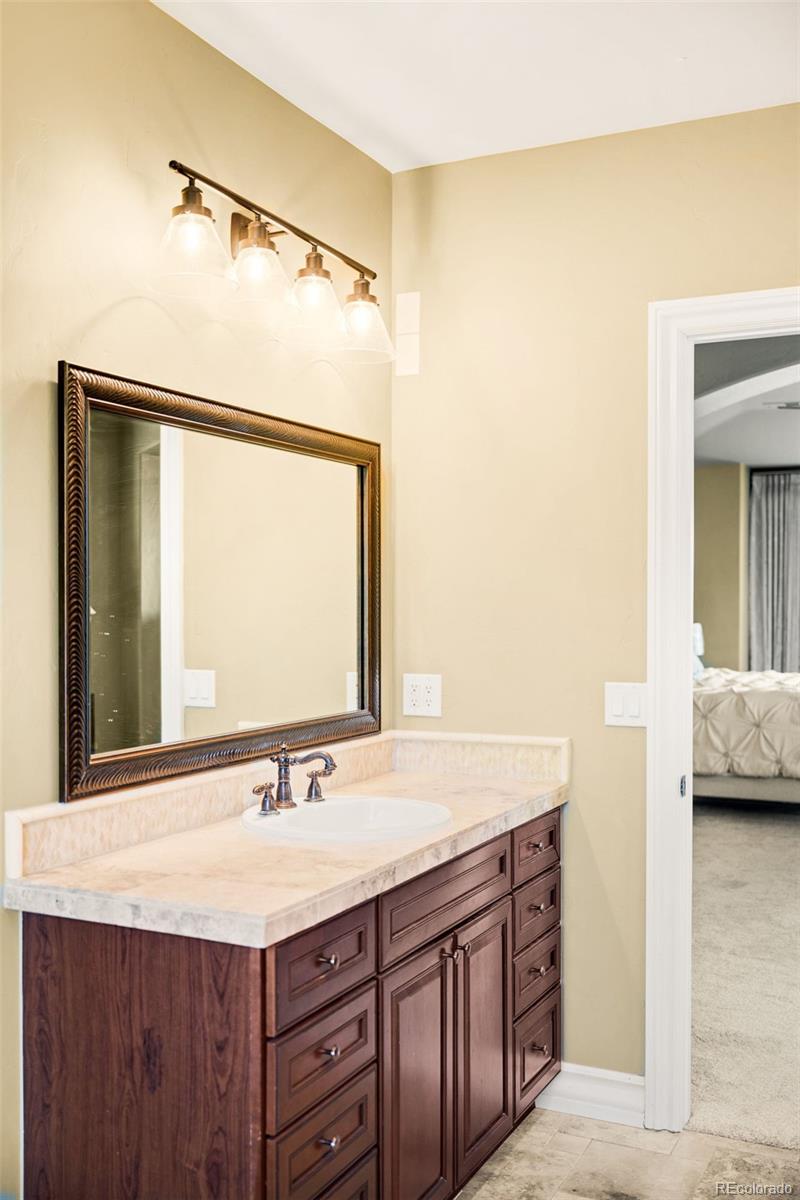 981 Buffalo Ridge Road Castle Pines, CO 80108 - Photo 30 of 49 a bathroom with a sink and a mirror