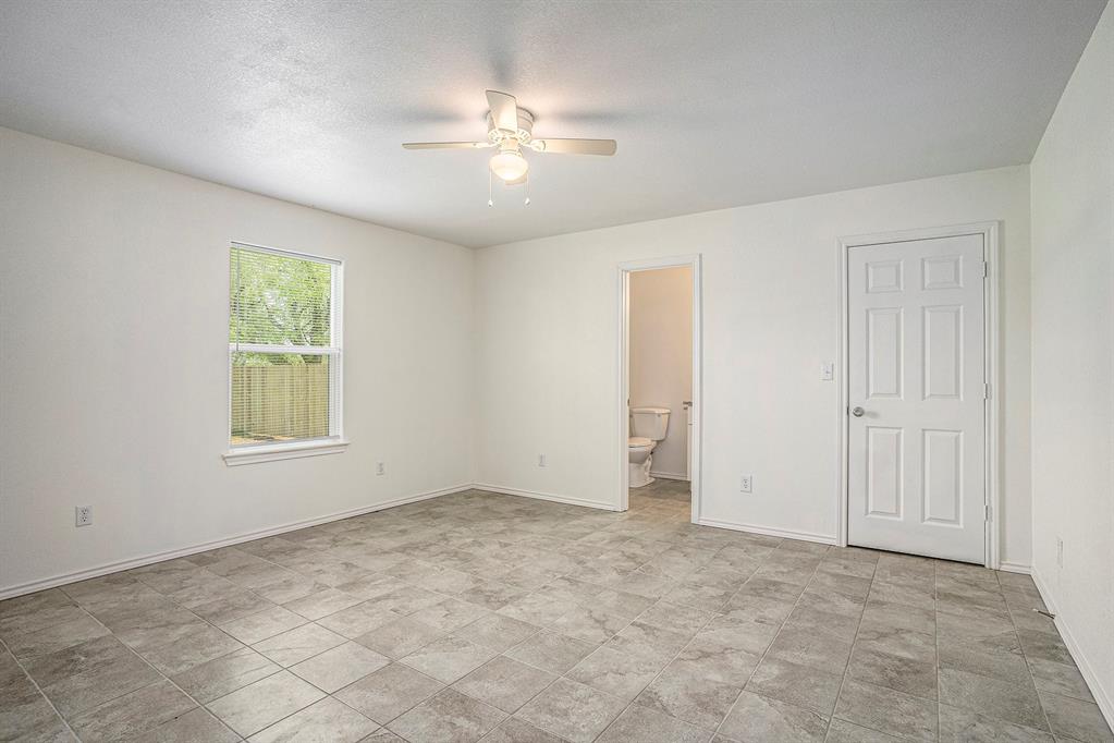 405 North Cleburne Whitney Road Rio Vista, TX 76093 - Photo 15 of 23 Spacious room with square tile flooring, a ceiling fan with integrated lighting, and a window providing natural light