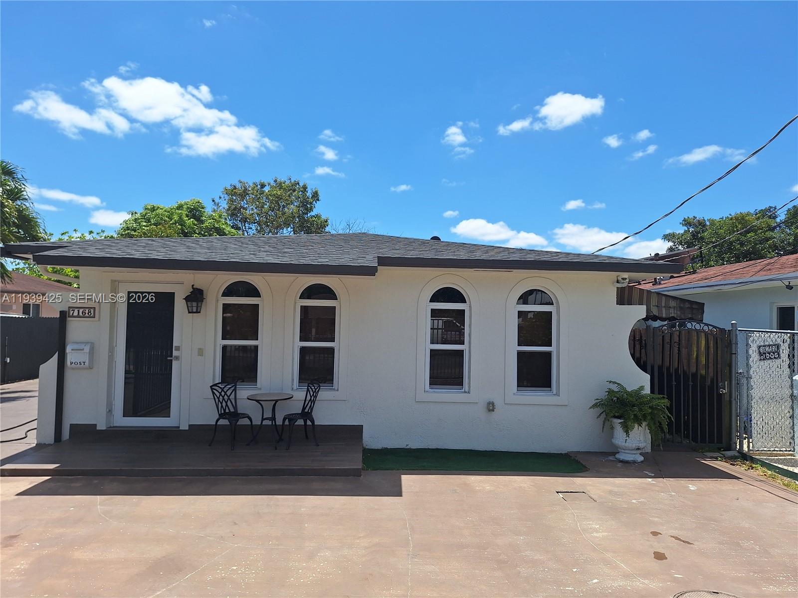 7168 Southwest 21st Street Miami, FL 33155 - Photo 1 of 9 a view of a house with backyard and sitting area