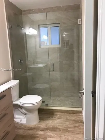 a bathroom with a toilet and a shower