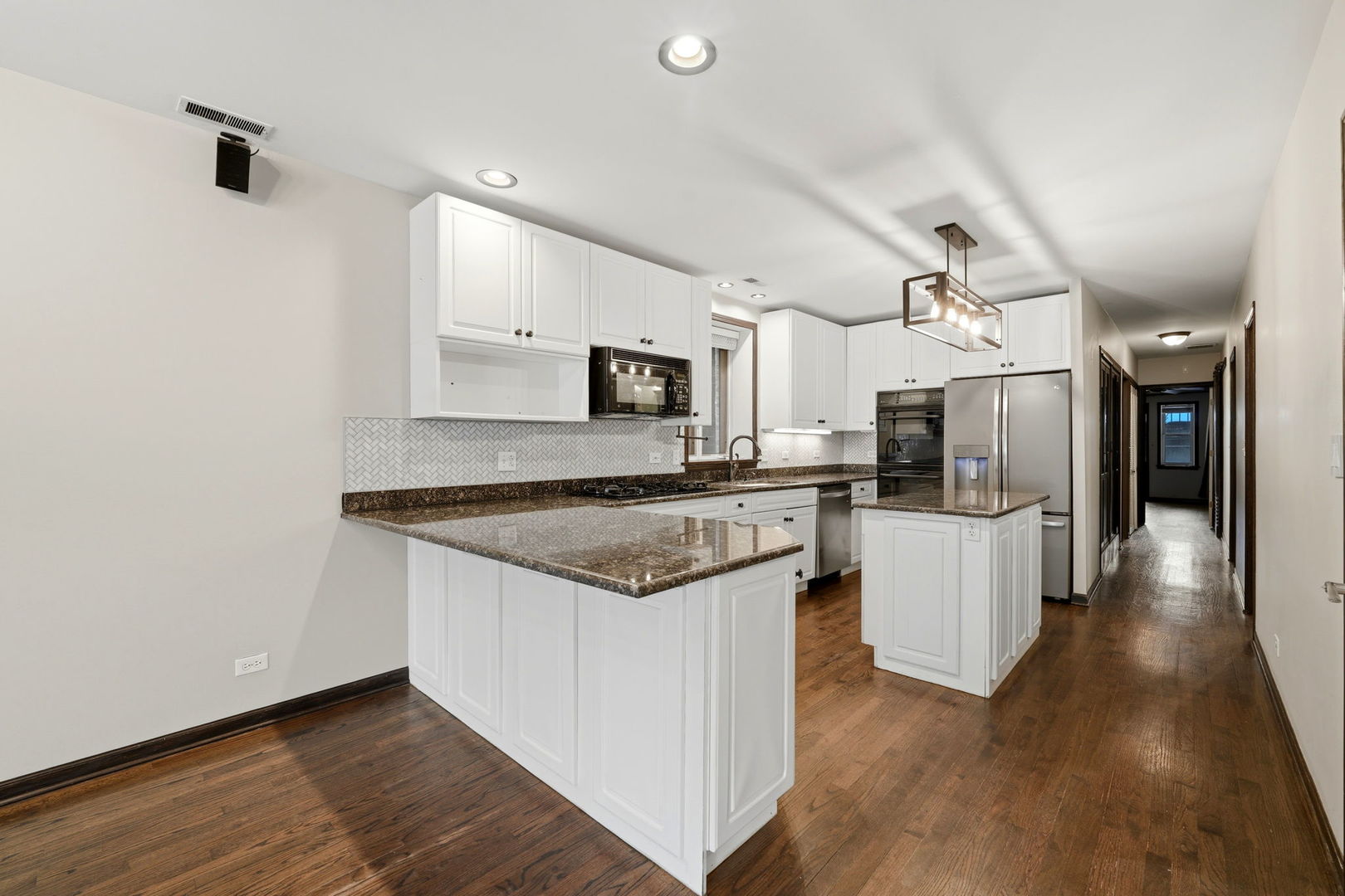 619 North Racine Avenue, Unit 1 Chicago, IL 60642 - Photo 15 of 36 a large kitchen with stainless steel appliances kitchen island a large counter top and a wooden floors