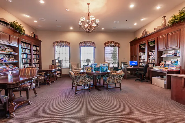 a living room with furniture a fireplace and a chandelier