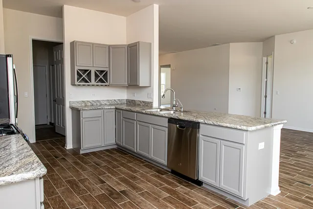 a kitchen with a sink stove and cabinets