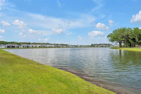 a view of a lake with houses in the background