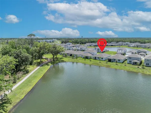 an aerial view of a house with a lake