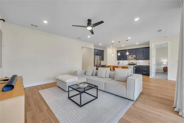 a living room with furniture and kitchen view