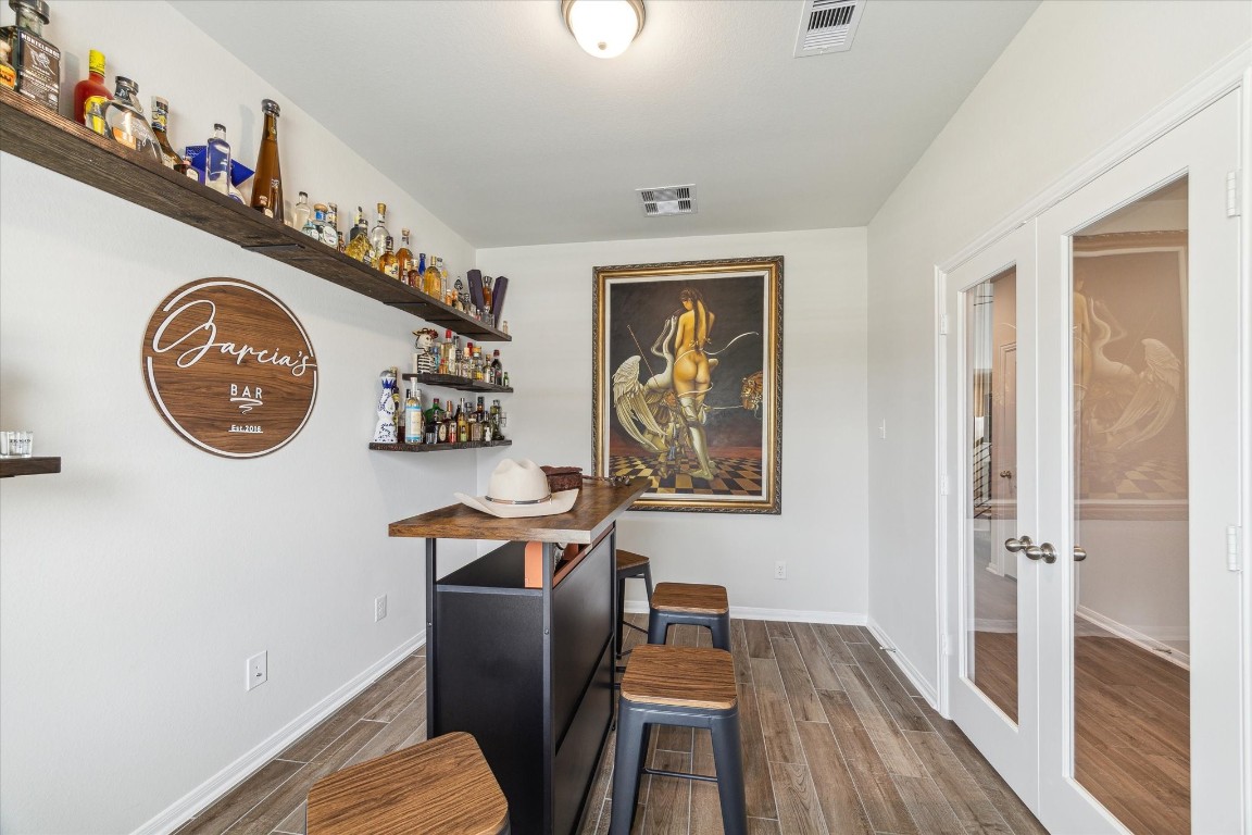 1523 Alpine Drive Rosharon, TX 77583 - Photo 13 of 25 a view of a workspace with furniture and wooden floor