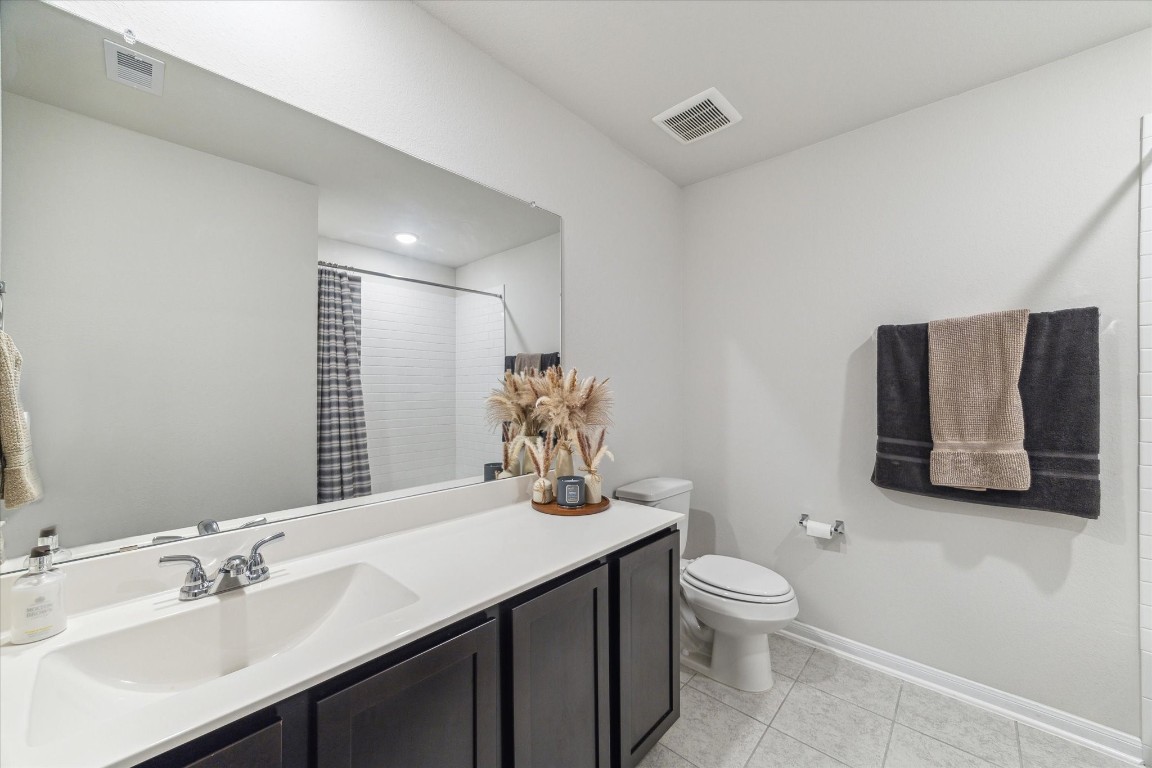 1523 Alpine Drive Rosharon, TX 77583 - Photo 14 of 25 a bathroom with a toilet a sink and mirror