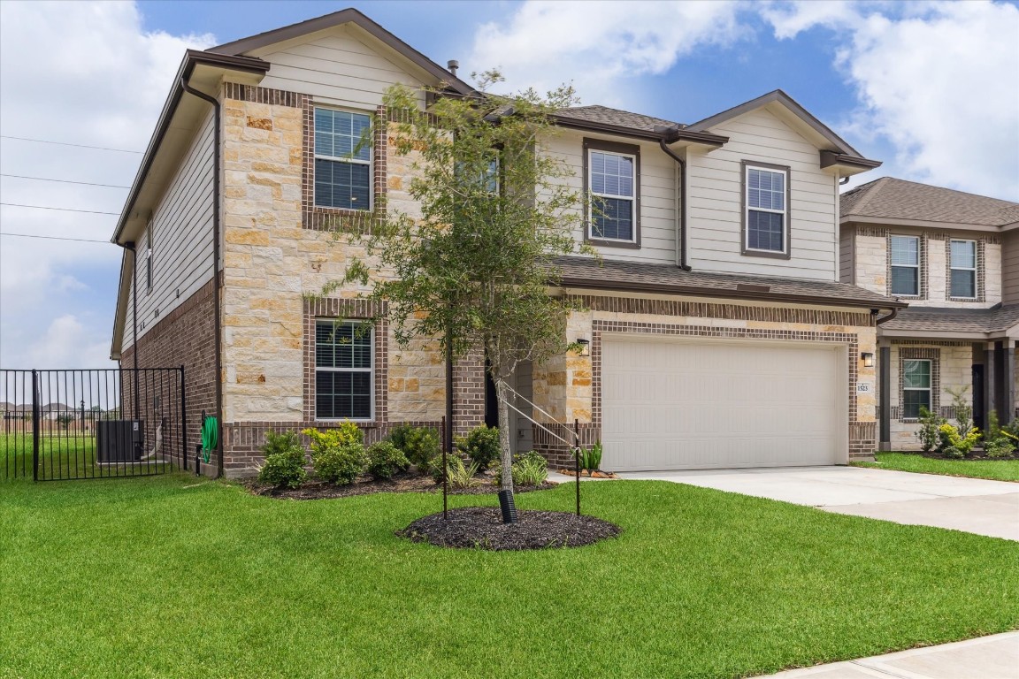 1523 Alpine Drive Rosharon, TX 77583 - Photo 2 of 25 a front view of a house with a garden and plants